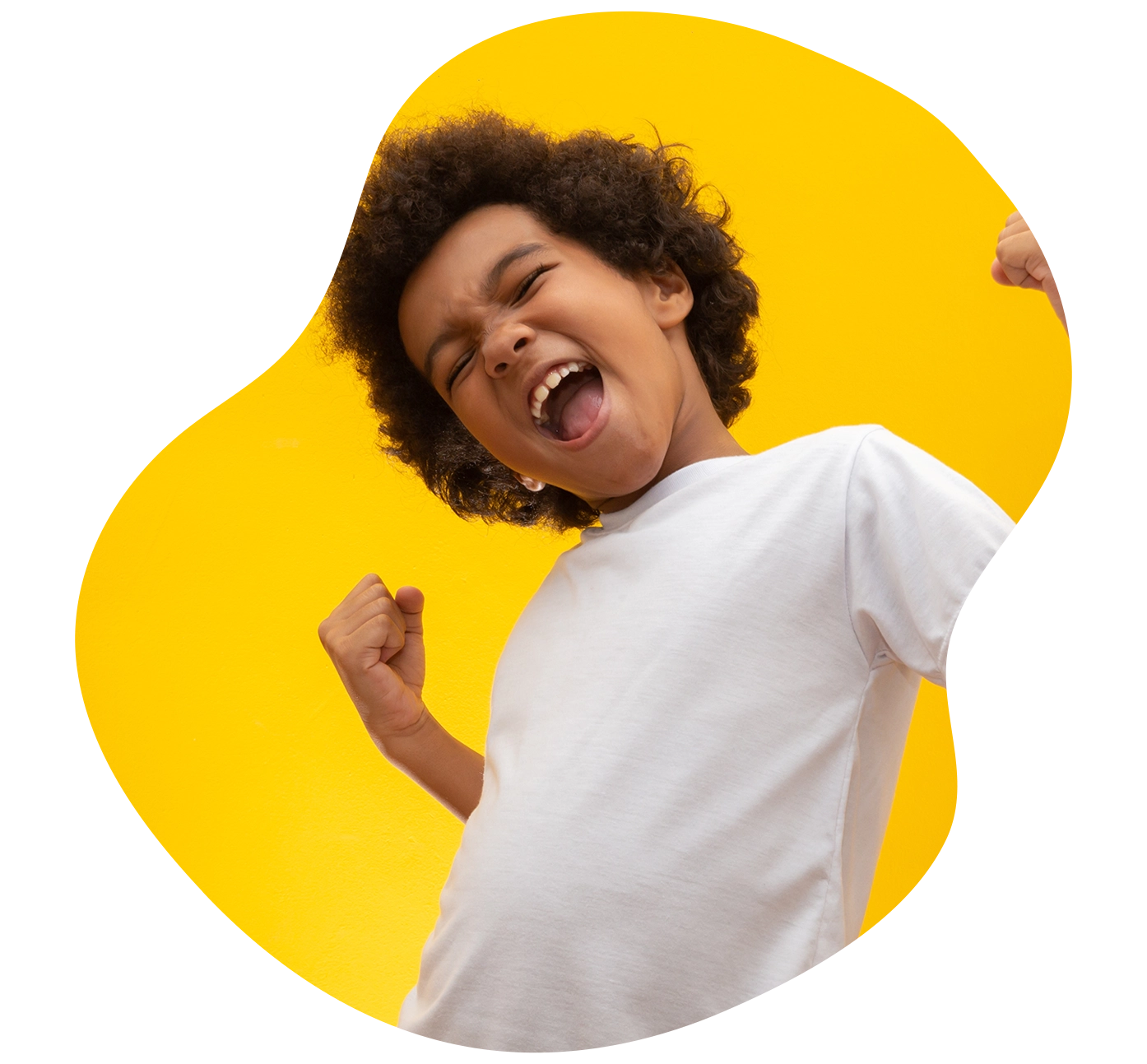 energetic young boy excitedly on yellow background